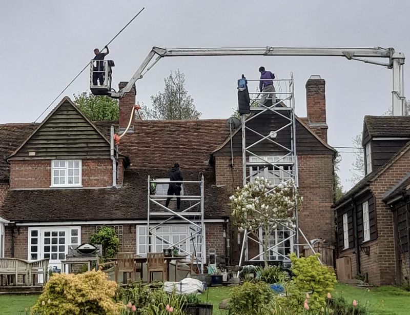 The Roof Moss Cleaners using cherry picker and scaffolding to clean roof safely and professionally in Baldock, Hertfordshire